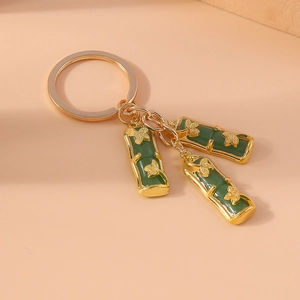 Close-up of Chinese style green bamboo joint keychain with golden metallic ring