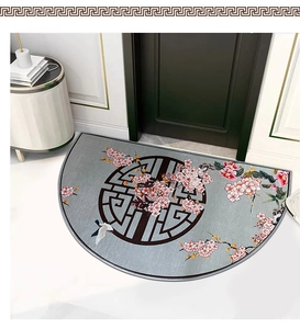 Detail of semi-circular gray door mat featuring a traditional Chinese bird and flower design