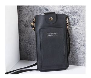 Close-up of black crossbody phone bag showing lychee grain texture and gold buckle
