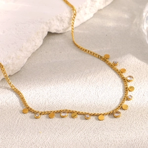 Detail of 18K gold-plated stainless steel chain with round discs and zircon stones
