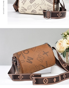 Detailed close-up of cylinder Boston bags in beige and brown with floral strap