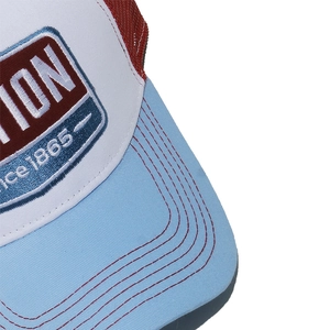 Detailed embroidery and stitching on a three-color vintage mesh trucker hat brim