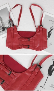 Detailed view of red faux leather corset belt with adjustable straps and metal buckles