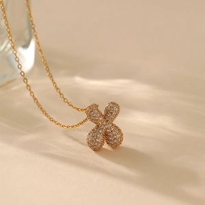 Macro shot of gold-plated necklace featuring a flower pendant with cubic zirconia stones