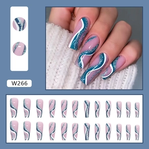 Long ballerina press-on nails with blue and white wavy patterns and glittery accents