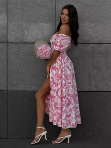 Detail of floral off-shoulder dress with puff sleeves and high slit in pink floral print