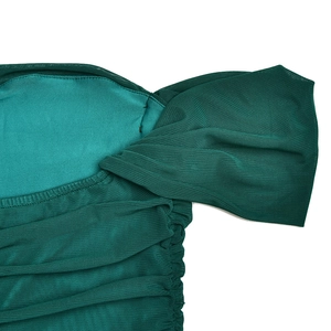 Detail view of the mesh stitching and pleated texture on this elegant off-shoulder dress