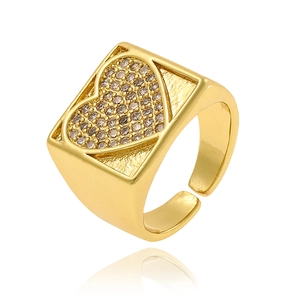 Detail of adjustable gold signet ring with textured heart and champagne gemstone