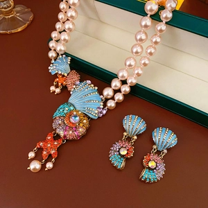 Detail of vintage enamel shell and starfish necklace with double-layer pink pearls