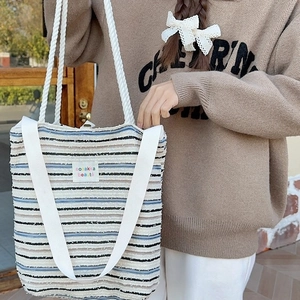 Striped canvas tote bag with woven rope handles and minimalist text patch for women