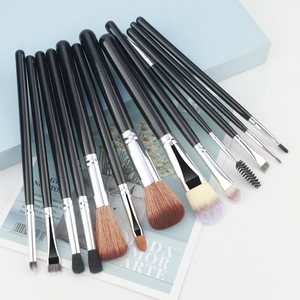 Detailed view of 13 professional makeup brushes with black handles on geometric blocks