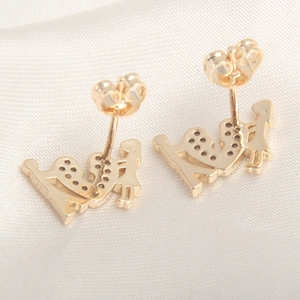 Exquisite 18k gold-plated heart bow crown earrings with zircon accents on white silk