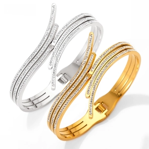 Detail of cross layered stainless steel bangles with sparkling pave zircons