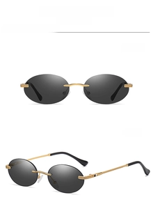 Detail view of gold-black C1 rimless oval sunglasses with sleek gold metal temples