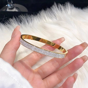 Macro view of gold plated bangle featuring three rows of pavé set cubic zirconia stones
