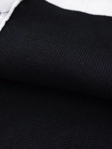Macro shot of high-quality black knitted fabric showing fine texture and soft density