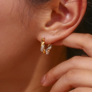 Close-up of 18K gold plated twisted hoop earring with sparkling pavé zircon details
