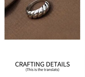 Macro detail of silver croissant dome ring showing heavy textured wave pattern
