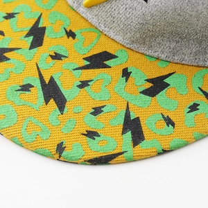 Close-up of hip hop baseball cap showing embroidery details and heart leopard print