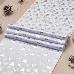 Detail of silver reindeer and snowflake patterns on velvet Christmas table runner