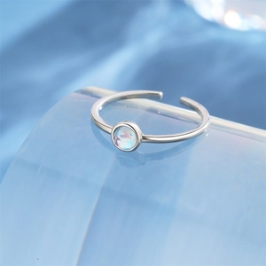 Macro detail of S925 sterling silver stamp and iridescent zircon stone on adjustable ring