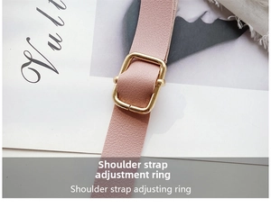 Detail of pink leather shoulder strap with adjustable golden metal buckle and texture