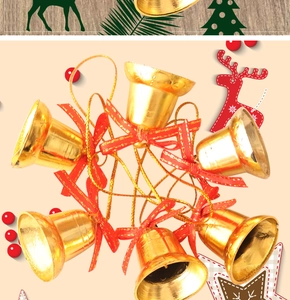 Close-up of golden Christmas bells with red silk bows and festive star patterns