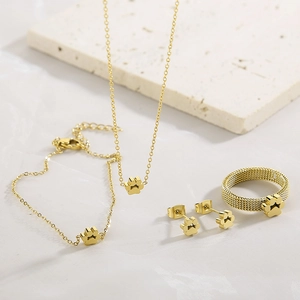 Golden mesh paw jewelry set with matching necklace, bracelet, earrings and ring on stone