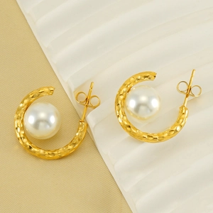 French style gold hammered C-shape earrings with white pearls on artistic display
