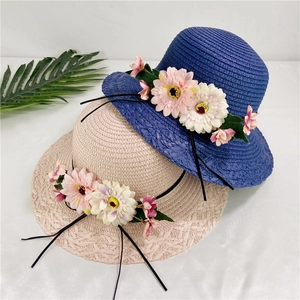 Straw sun hats for women with floral accents and ribbon in pink and blue colors