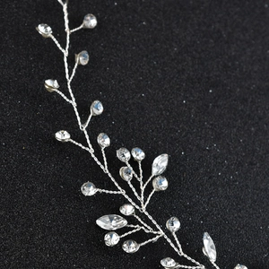 Close-up of silver metal vine bridal headpiece with sparkling crystals and rhinestones
