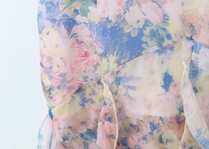 Close-up of floral chiffon dress hem showing tiered ruffles and detailed stitching