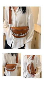 Close-up of brown textured leather waist bag with thick silver chain and star buckle
