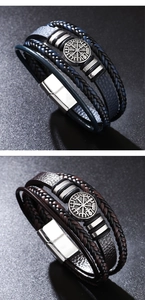 Detail of multi-layer braided leather bracelets featuring a metal Nordic compass charm