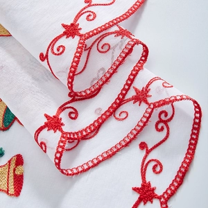 White Christmas cafe curtain featuring red embroidery of bells and festive stars