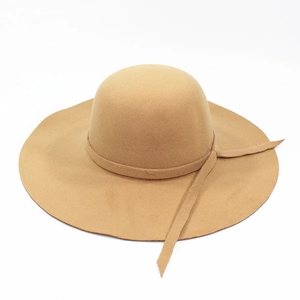 Detail of camel wool fedora hat featuring a wide wavy brim and elegant round dome top