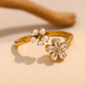 Detailed close-up of an 18K gold-plated floral ring with zircon and pearl accents