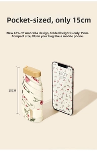 Mini 15cm folding umbrella with cherry print and gold handle shown next to a smartphone