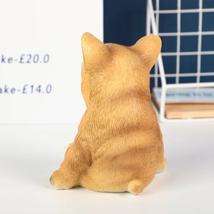 Rear view of a cute resin pug dog ornament with realistic ginger fur texture for home decor