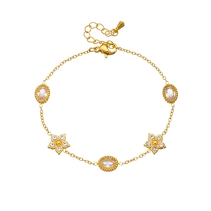 Gold stainless steel bracelet with oval zircons and crystal floral charms on white base