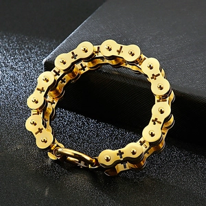 Close-up of golden bicycle chain bracelet with cross hollow pattern and mechanical clasp
