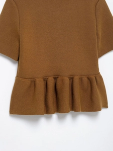 Detailed view of brown knit short sleeve top with delicate ruffled hem and texture