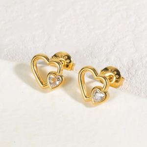 Macro shot of gold stainless steel heart earrings with sparkling heart-shaped zircon stones