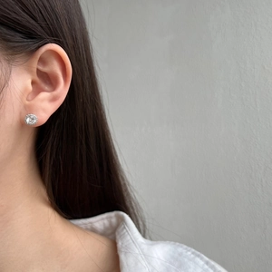 Close-up of a model wearing a S925 sterling silver earring with a large zircon center stone