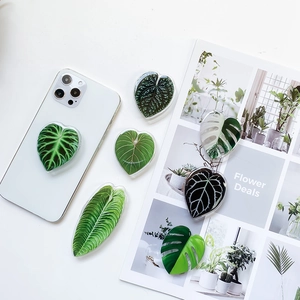 Macro shot of tropical leaf griptok holder on a smartphone with a clean white aesthetic