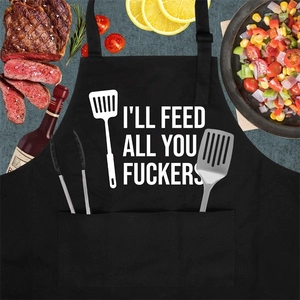 Schwarze Küchenschürze mit dem Aufdruck I'll Feed All You Fuckers und Besteckgrafiken