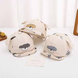 Detail of embroidered puppy faces and 3D ears on textured baby corduroy baseball caps