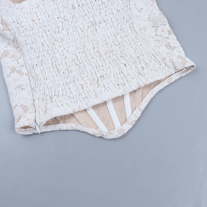 Close-up of white lace corset top featuring interior boning and invisible zipper detail