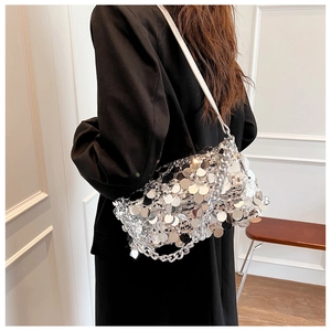 Close-up of silver sequin shoulder bag with metallic chain and white leather strap
