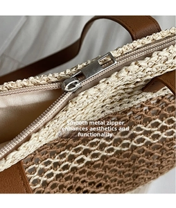 Macro shot of smooth metal zipper pull and premium straw leather patchwork detail